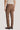 Tobacco brown plain front trouser on male model, rear view, with dark leather shoes.