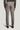 Light brown single pleat trousers with front crease and button flap pockets, shown from back view.