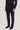 Navy corduroy tailored trousers with side tabs and pleated front, worn with dark loafers.