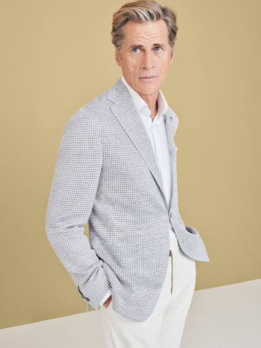 man wearing grey blazer, shirt and trousers