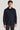 Navy wool shirt jacket with collar and front button closure, featuring two chest pockets.