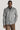 Grey and white herringbone shirt jacket with button front, worn over navy shirt and brown corduroy pants.