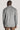 Man wearing grey herringbone shirt jacket with collar, shown from back view.