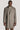 Taupe twill topcoat with notch lapels, two-button front closure, patch pockets, and cream-colored removable bib insert.