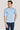 Man wearing light blue short-sleeve polo shirt with collar and button front, paired with dark navy pants.