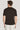Man wearing black short-sleeve crew neck t-shirt, shown from back view.