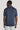 Dark blue button sweater with short sleeves and ribbed collar, shown from back view on model.