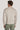 Beige crew neck sweater with long sleeves, shown from back on model wearing olive green pants.
