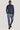 Man wearing navy quarter-zip pullover and blue jeans.