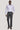 Man wearing lilac long-sleeve button-up dress shirt with charcoal trousers and brown loafers.