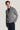 Charcoal ribbed cardigan with shawl collar and button front, worn over black shirt and navy pants.