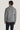 Man wearing charcoal ribbed cardigan with shawl collar and dark navy trousers, shown from back view.
