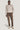 Sand crewneck sweatshirt with ribbed cuffs and neckline worn with brown pants.