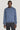 Blue crew neck sweatshirt with ribbed trim worn with black pants.