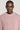 Pink crewneck sweatshirt with ribbed texture and crew neckline, worn by a person against a neutral background.