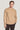 Beige crewneck sweater with cable knit pattern worn with dark trousers.