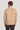 Beige crewneck sweater with ribbed knit texture, shown from back on model wearing dark pants.