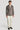 Tan herringbone blazer with double-breasted buttons styled with cream shirt and white trousers.