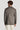 Tan herringbone blazer with notch lapels and long sleeves, shown on model from back view.