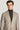 Man wearing light tan herringbone blazer over charcoal turtleneck, front view.