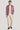 Man wearing mauve melange blazer with notch lapels and buttons over cream t-shirt and cream trousers.